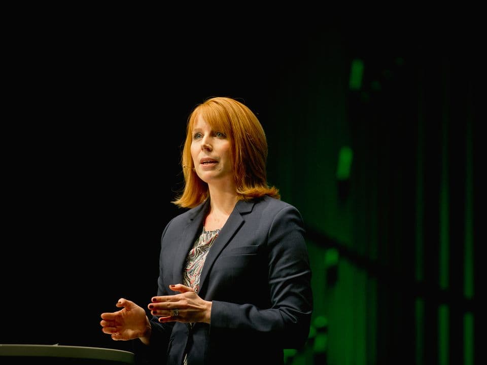 Annie Lööf on a dark stage